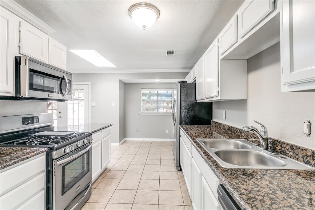 845 Lovers Lane Grapevine, TX 76051 - Photo 9 of 24 a kitchen with a sink stove top oven and cabinets