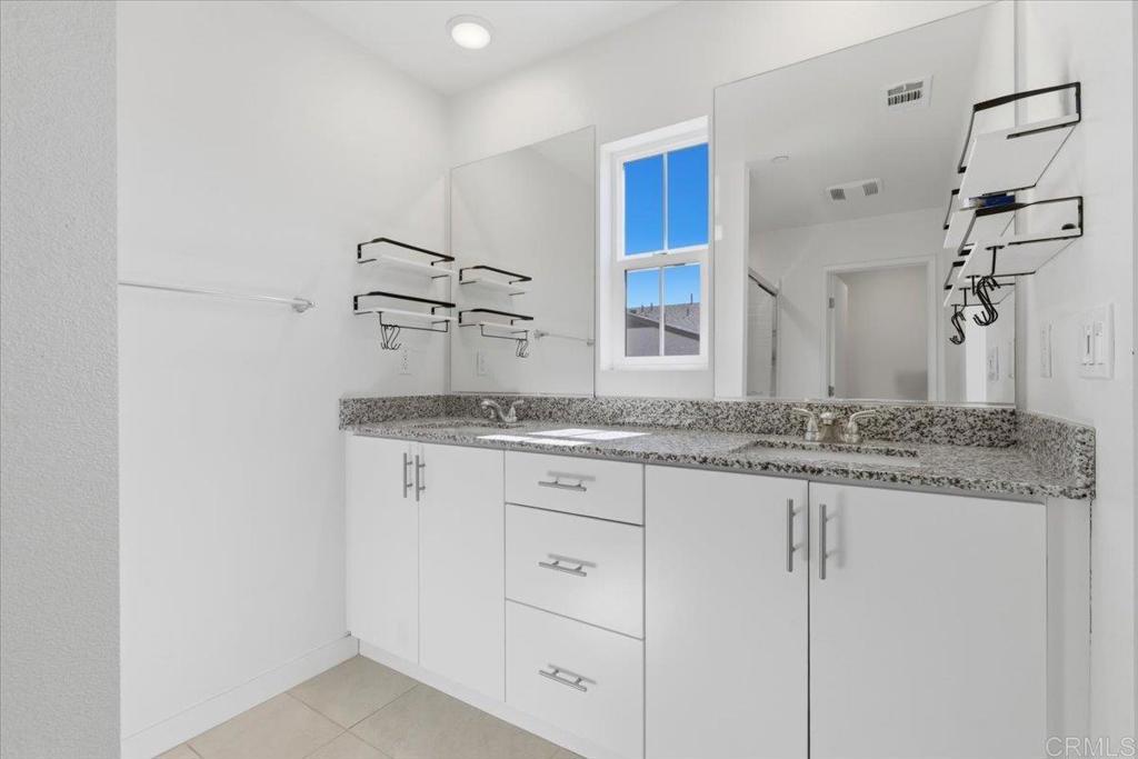 35180 Grove Trail Fallbrook, CA 92028 - Photo 17 of 23 a bathroom with a granite countertop sink and a mirror
