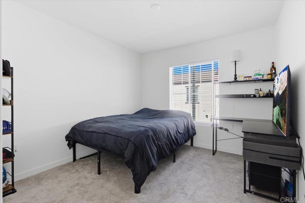 35180 Grove Trail Fallbrook, CA 92028 - Photo 18 of 23 a bedroom with a bed and a flat tv screen on wall