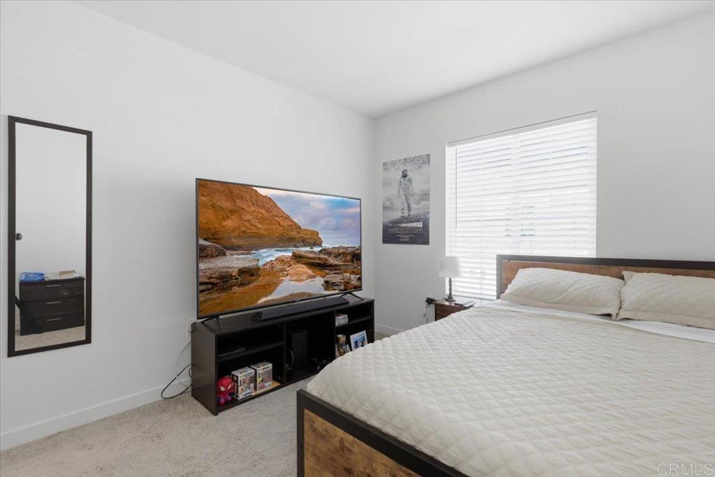 35180 Grove Trail Fallbrook, CA 92028 - Photo 21 of 23 a bedroom with a bed and a flat screen tv