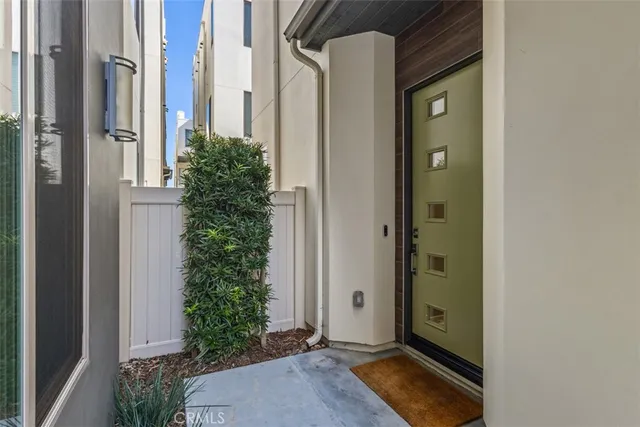 a view of small space with potted plants in front of door