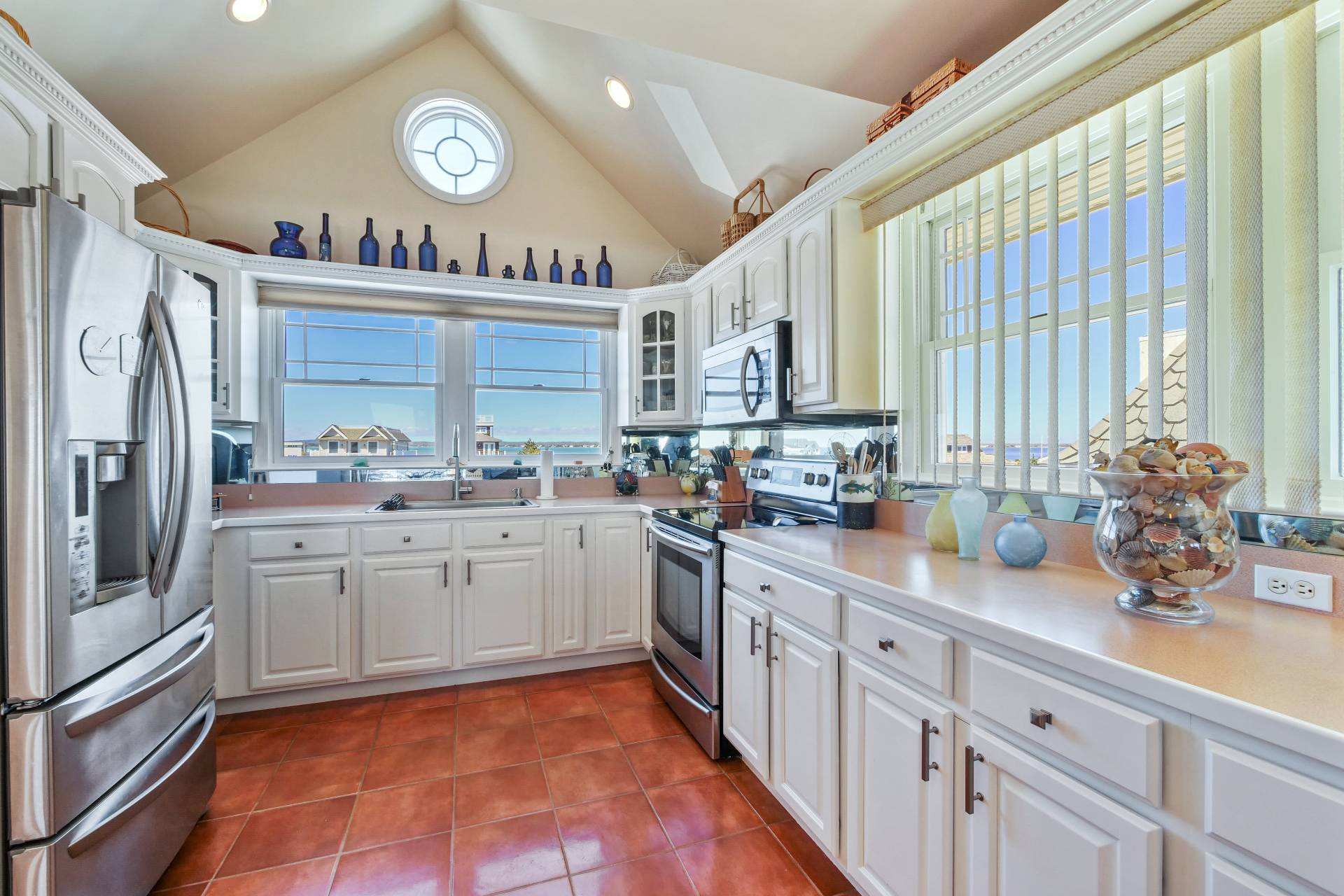805 Dune Road Westhampton Beach, NY 11978 - Photo 12 of 25 a kitchen with stainless steel appliances a sink and a refrigerator