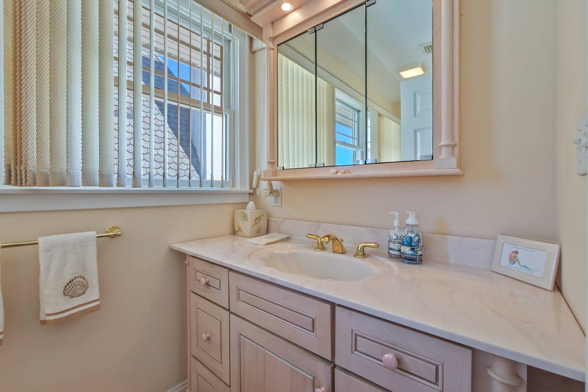 805 Dune Road Westhampton Beach, NY 11978 - Photo 20 of 25 a bathroom with a sink and a mirror