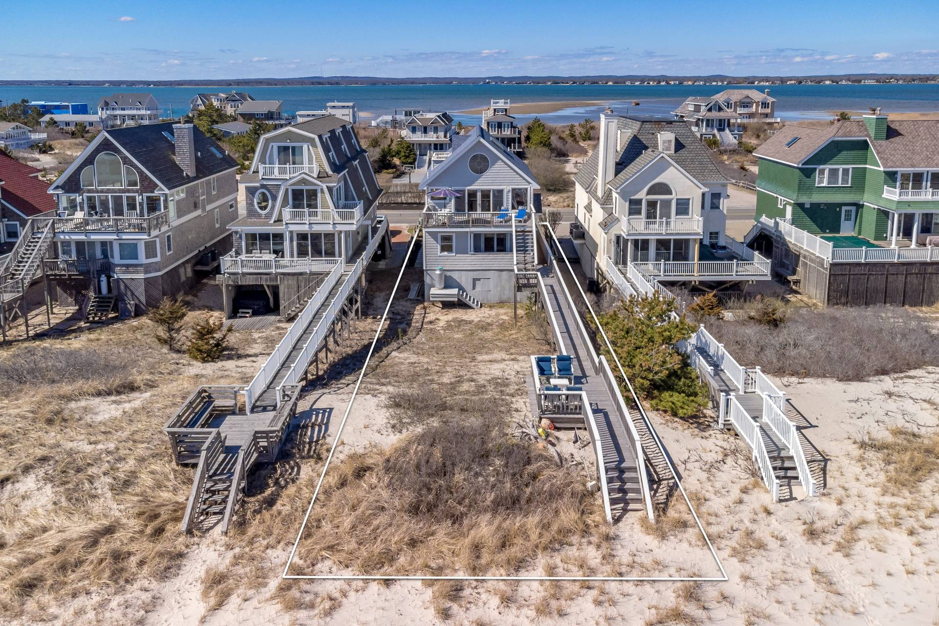 805 Dune Road Westhampton Beach, NY 11978 - Photo 5 of 25 an aerial view of residential houses with wooden stairs