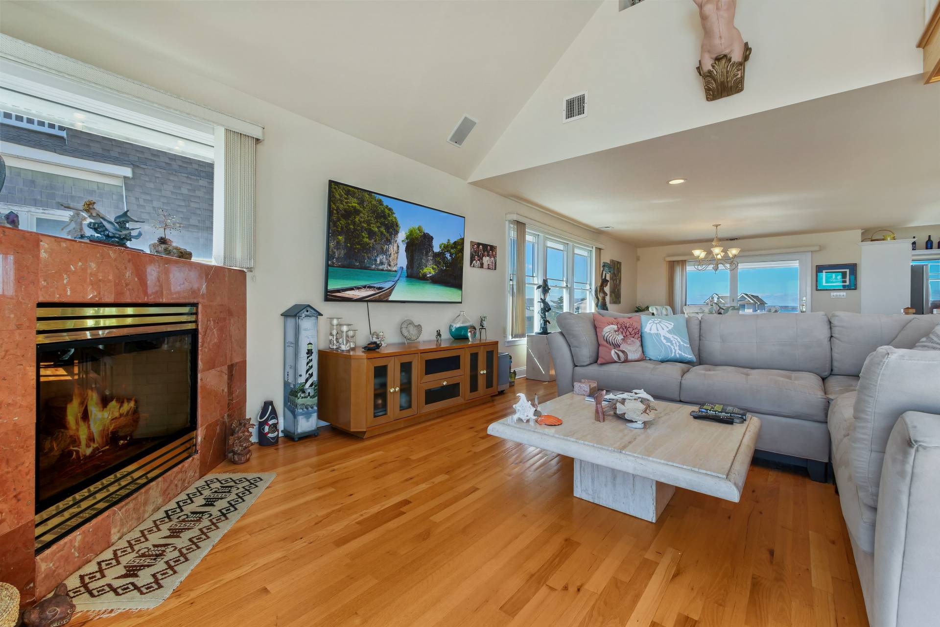 805 Dune Road Westhampton Beach, NY 11978 - Photo 8 of 25 a living room with furniture a fireplace and a flat screen tv