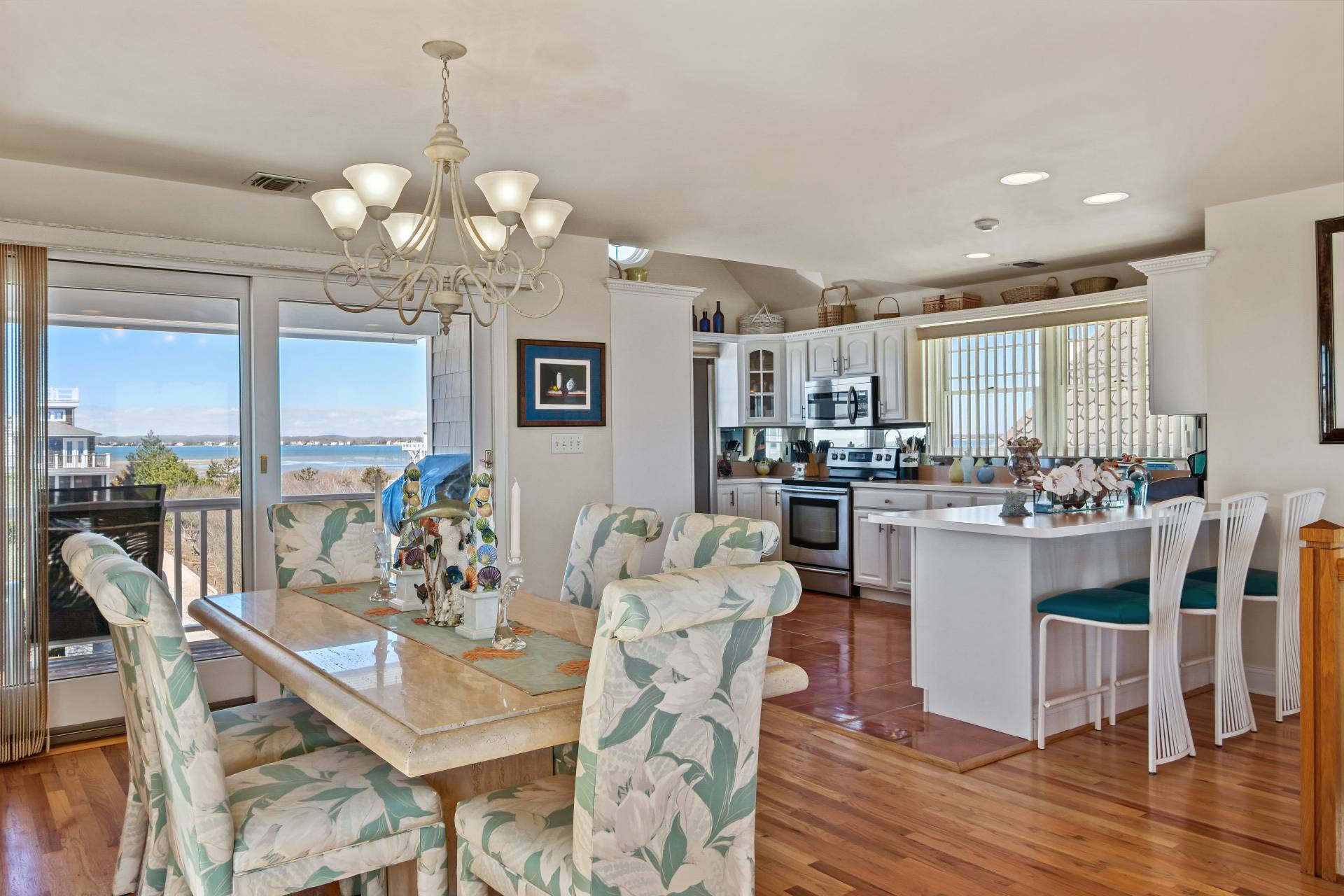 805 Dune Road Westhampton Beach, NY 11978 - Photo 10 of 25 a view of a dining room with furniture large windows and wooden floor