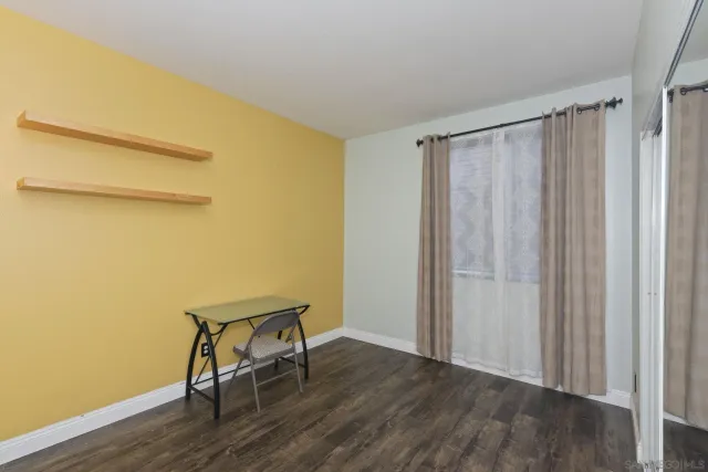 a view of a hallway with wooden floor and stairs