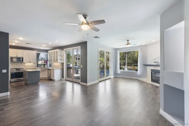 a open kitchen with white cabinets and stainless steel appliances