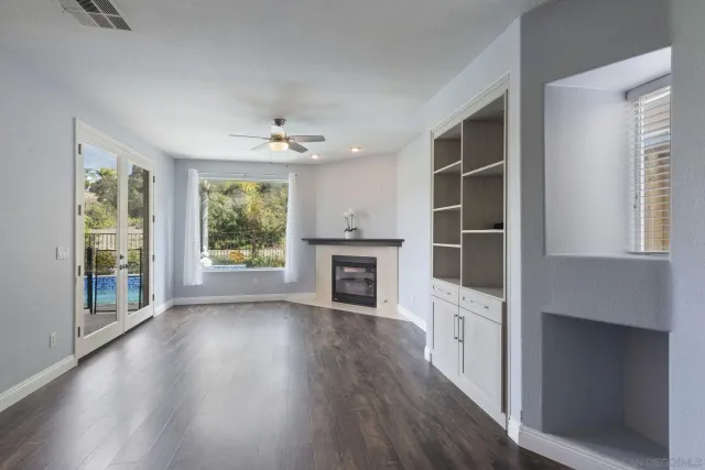 a kitchen with a refrigerator and white cabinets