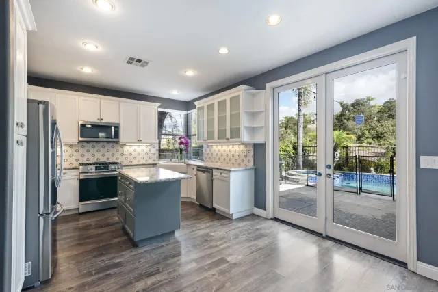 a kitchen with a white cabinets and a stove top oven