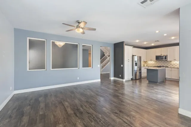 an empty room with wooden floor and sliding door