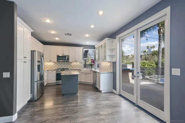 a bathroom with a double vanity sink toilet and shower