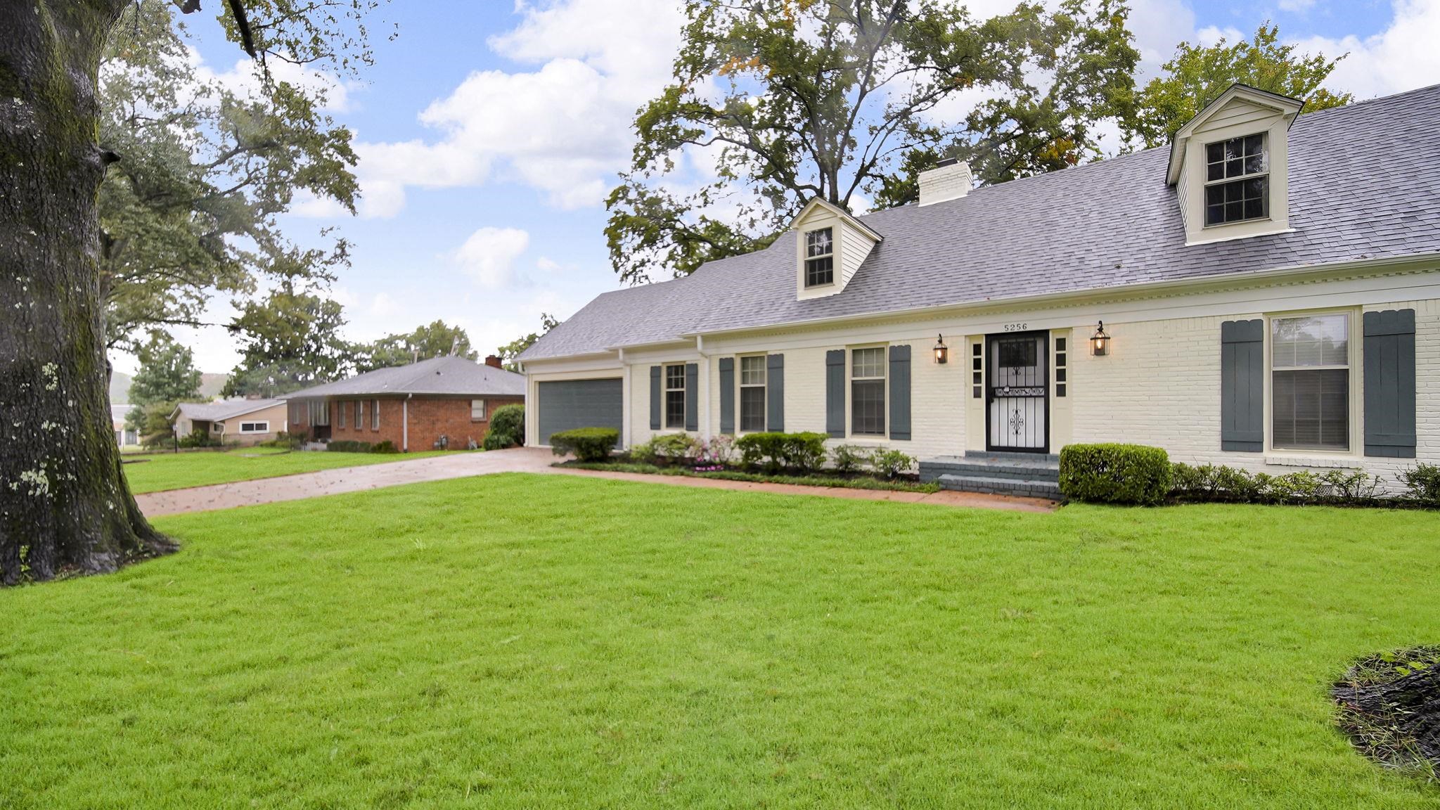 5256 Collingwood Road Memphis, TN 38117 - Photo 2 of 40 New england style home with driveway, a front yard, a shingled roof, a chimney, and brick siding