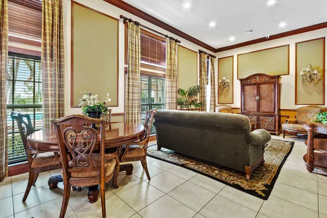 a living room with furniture and a floor to ceiling window
