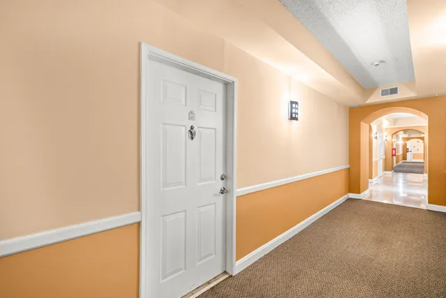 a view of a hallway with a room