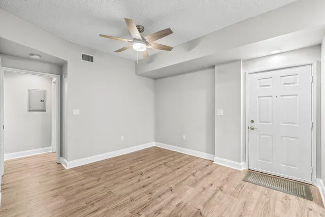 a view of an empty room and wooden floor