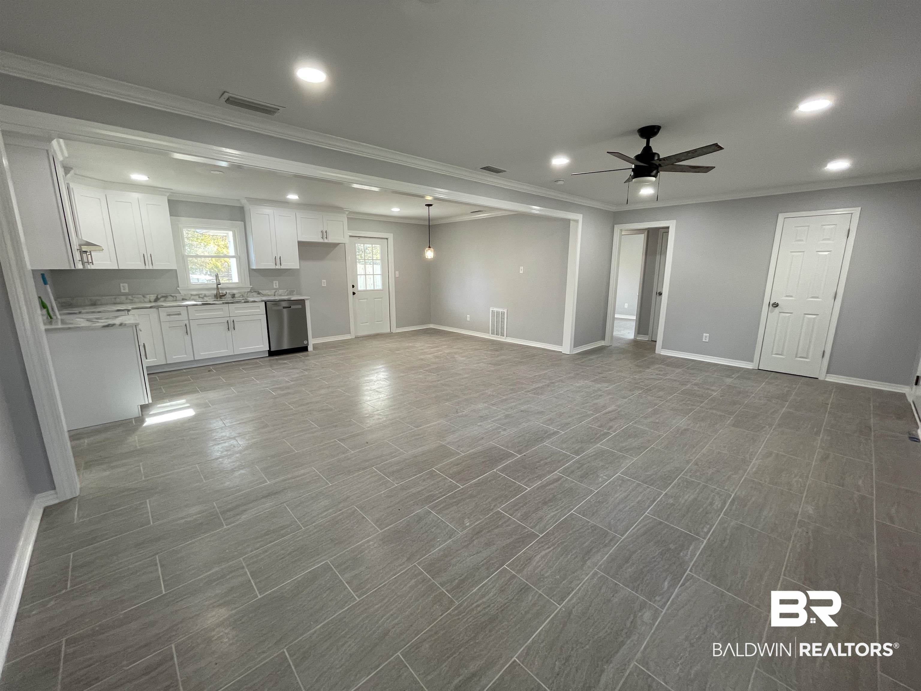 3901 Prima Vera Lane Mobile, AL 36605 - Photo 7 of 15 Unfurnished living room with crown molding and ceiling fan