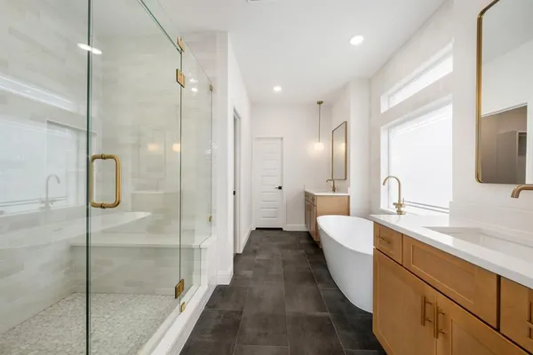 a bathroom with a double vanity sink mirror and shower