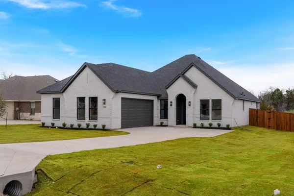 a front view of house with yard and green space