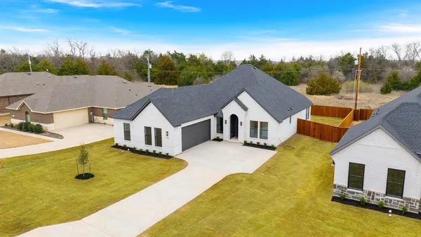 a view of house with yard and swimming pool