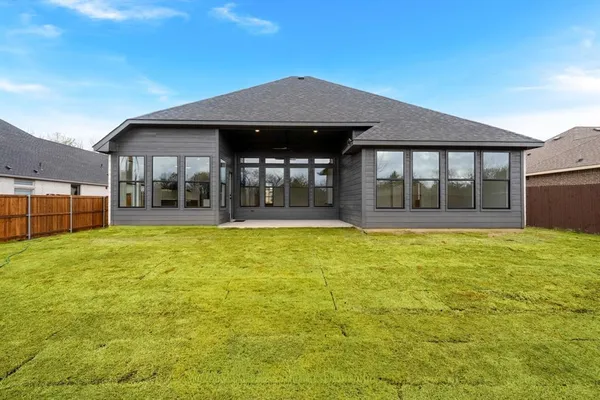 a house view with swimming pool in front of it