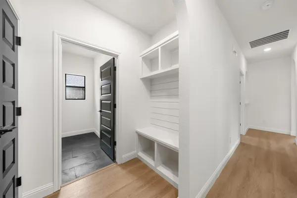 a view of hallway with stairs and wooden floor