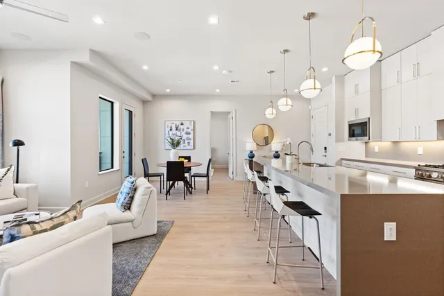 a very nice looking living room with dining room and couches