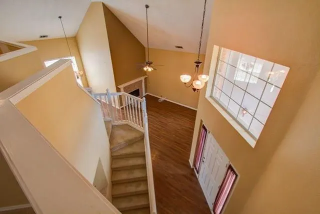 a kitchen with granite countertop a stove a sink and a refrigerator
