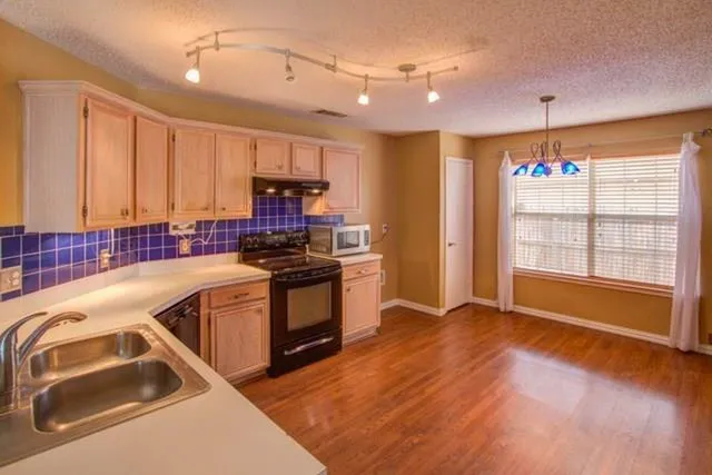 a kitchen with a sink cabinets and window