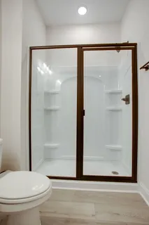 a bathroom with a glass shower door
