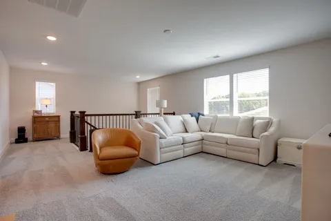 a living room with furniture a window and a couch