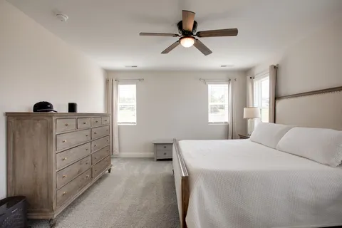 a bedroom with a bed and a dresser