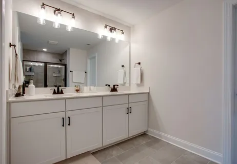 a bathroom with a double vanity sink and a mirror