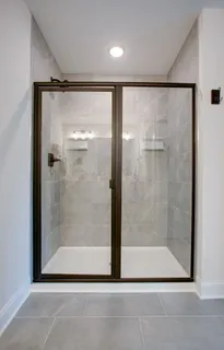 a bathroom with a glass shower door