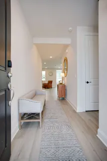 a view of living room filled with furniture and wooden floor