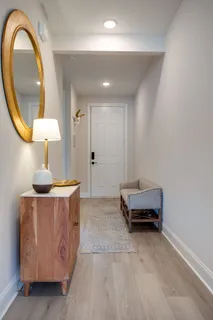 a living room with furniture and a mirror