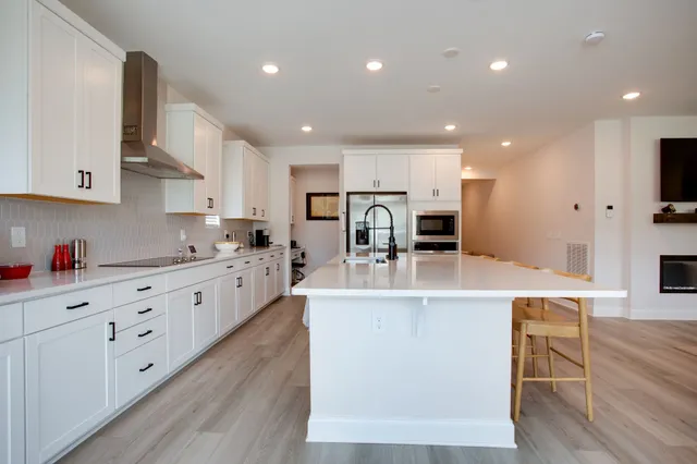 a large kitchen with stainless steel appliances lots of counter top space
