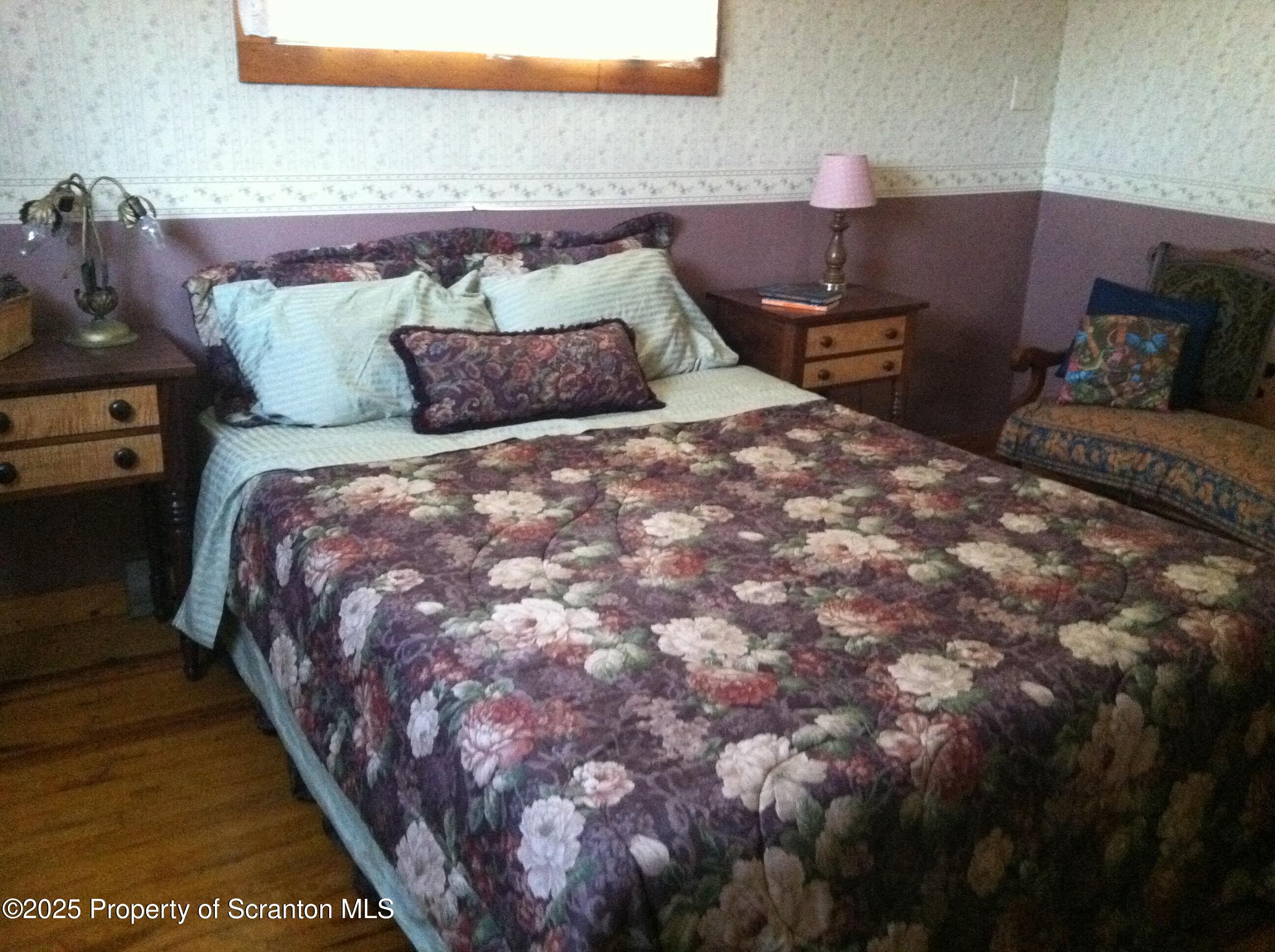 270 Starrucca Creek Road Starrucca, PA 18462 - Photo 21 of 51 a bed sitting in a bedroom next to a lamp