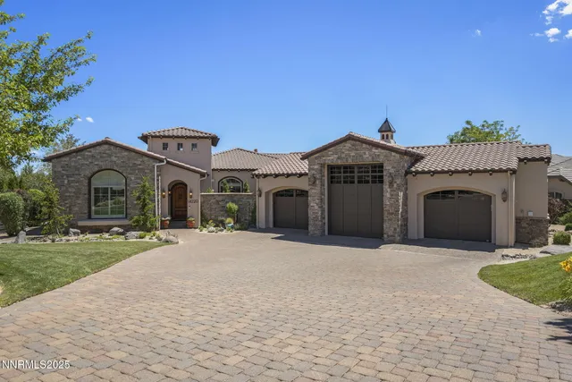 a front view of a house with a garden and yard