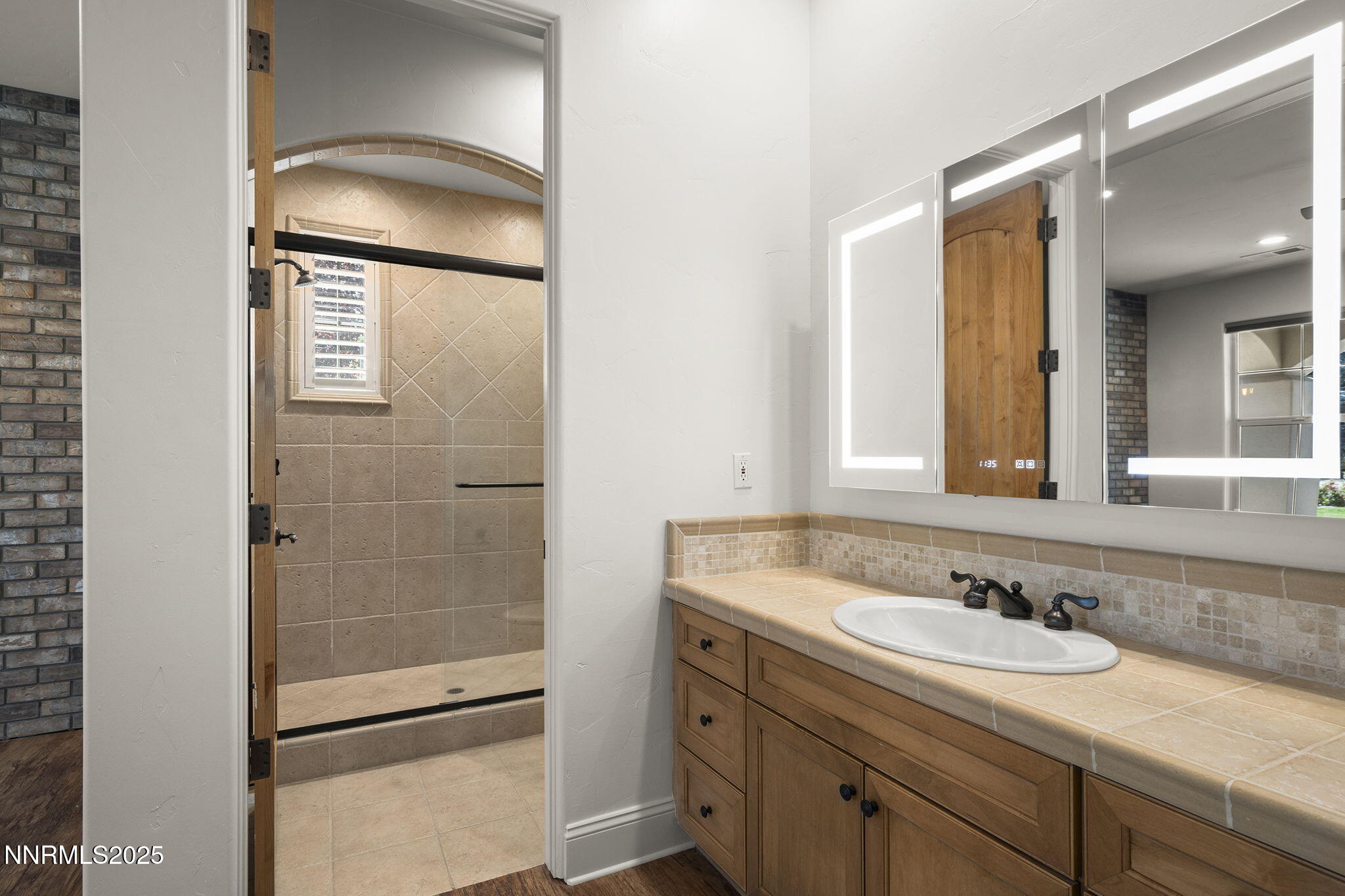 14220 Eagle Springs Court Reno, NV 89511 - Photo 45 of 57 a bathroom with a granite countertop sink and a mirror