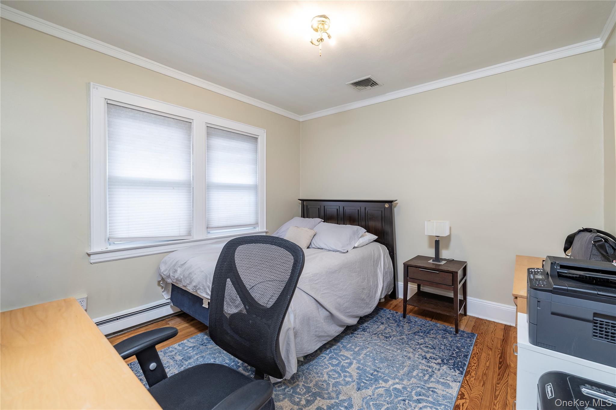 3016 Roxbury Road Oceanside, NY 11572 - Photo 12 of 24 a bedroom with a bed and a window