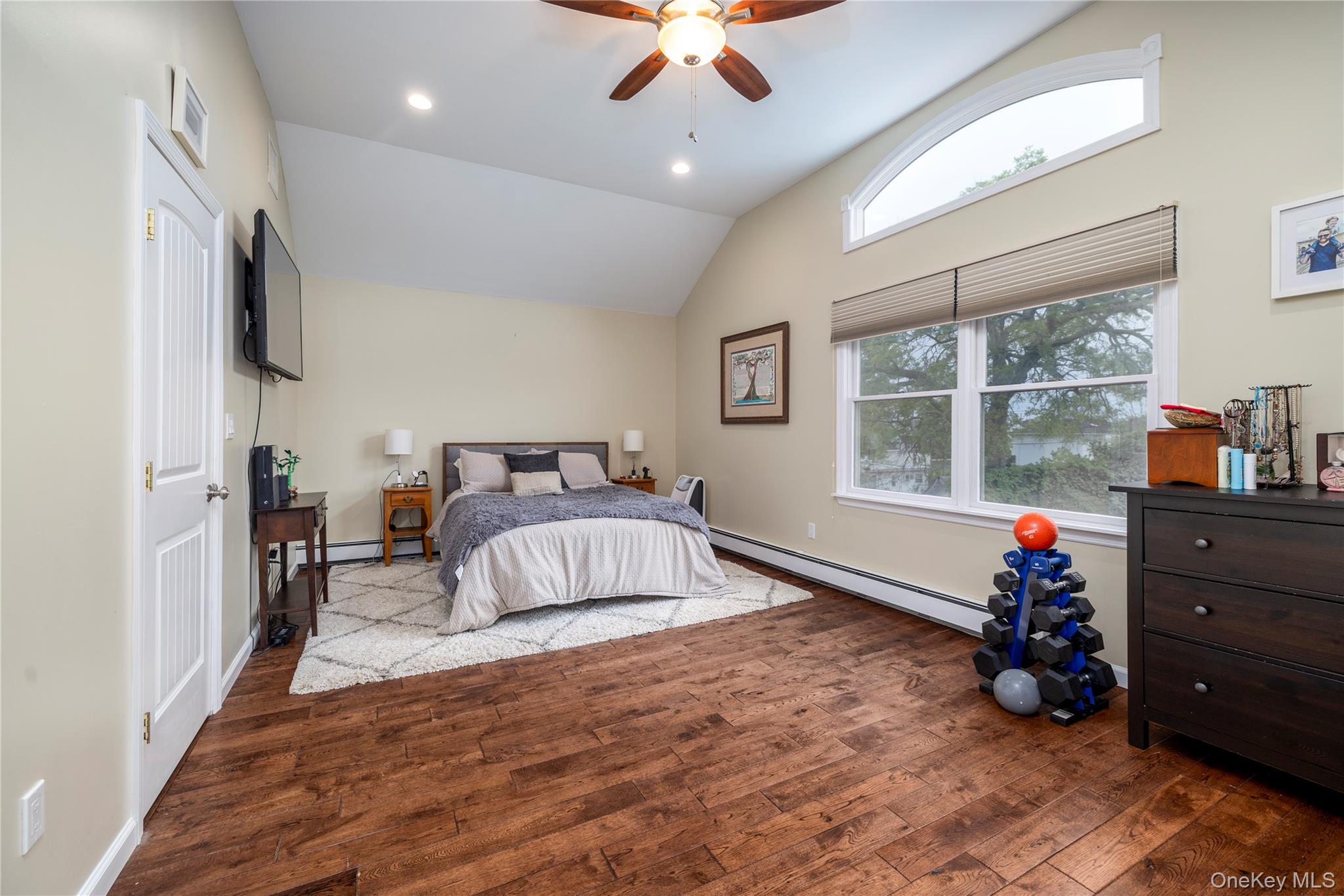 3016 Roxbury Road Oceanside, NY 11572 - Photo 15 of 24 a bedroom with a bed and a chandelier