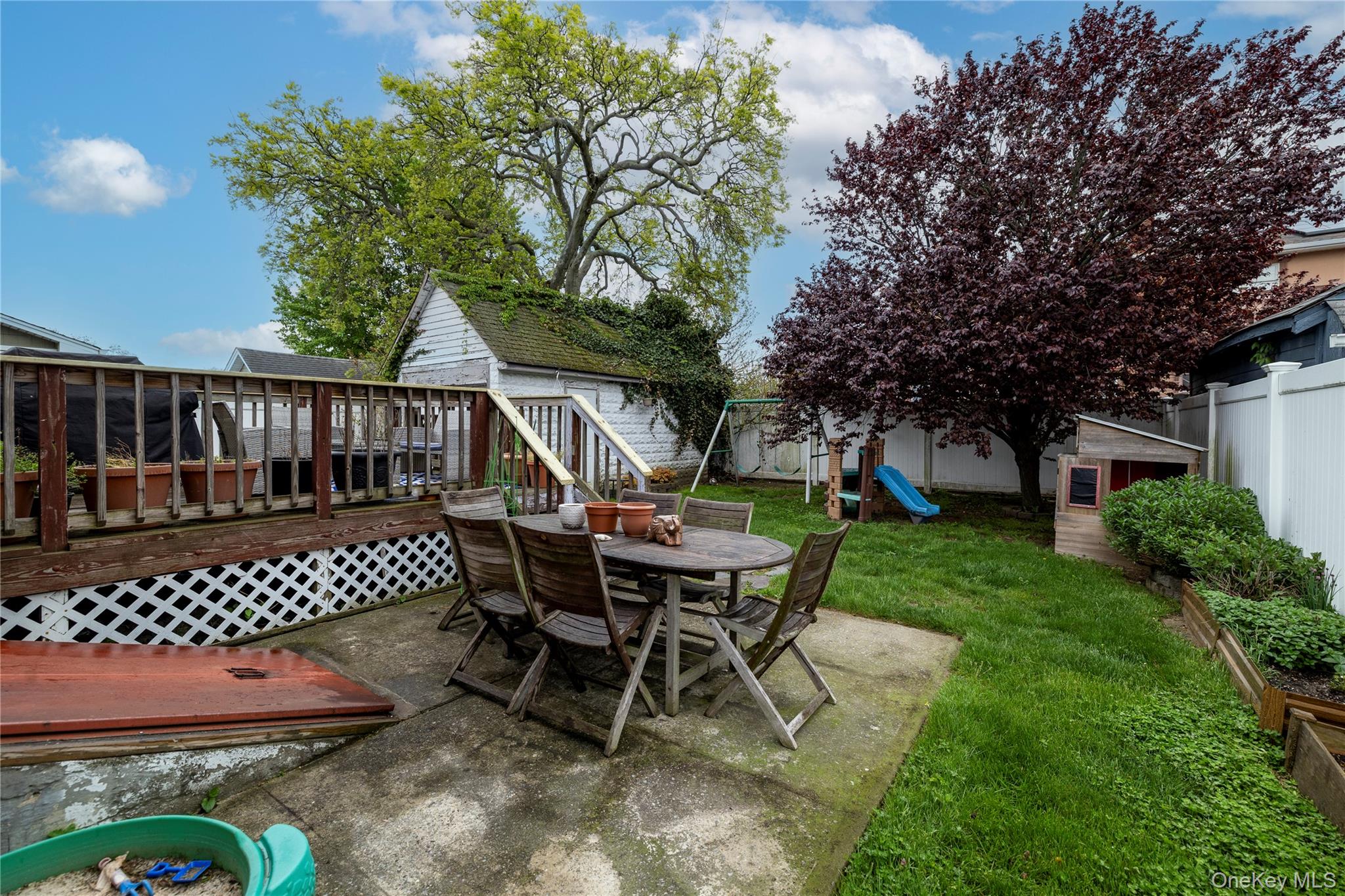 3016 Roxbury Road Oceanside, NY 11572 - Photo 22 of 24 a view of a patio with a table chairs and a table