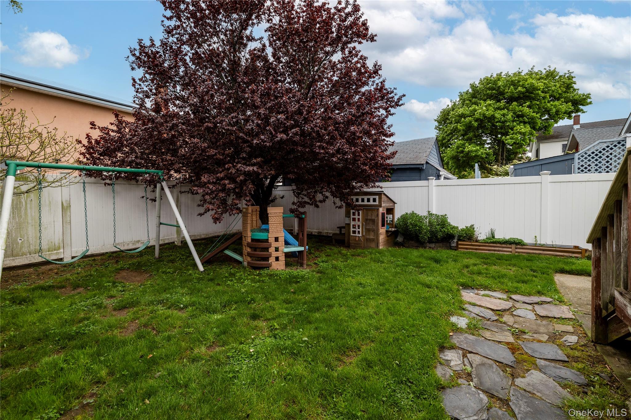 3016 Roxbury Road Oceanside, NY 11572 - Photo 23 of 24 a view of a backyard with a garden and entertaining space