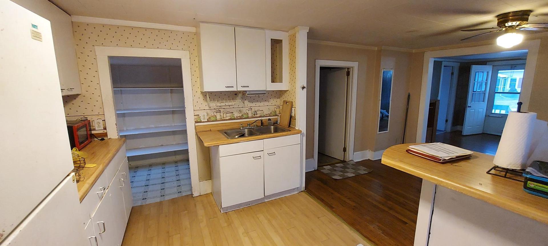 506 State Street New Windsor, IL 61465 - Photo 5 of 10 a room with a bed and furniture