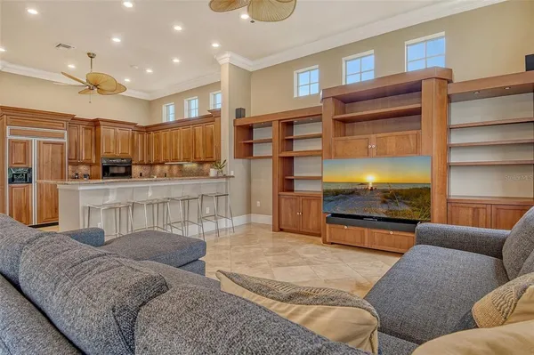 a living room with furniture and a ceiling fan