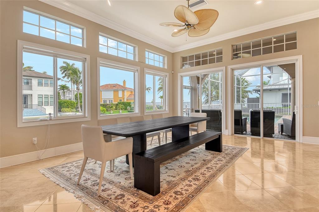 591 Putting Green Lane Longboat Key, FL 34228 - Photo 16 of 68 a view of a living room and kitchen with a table or chairs