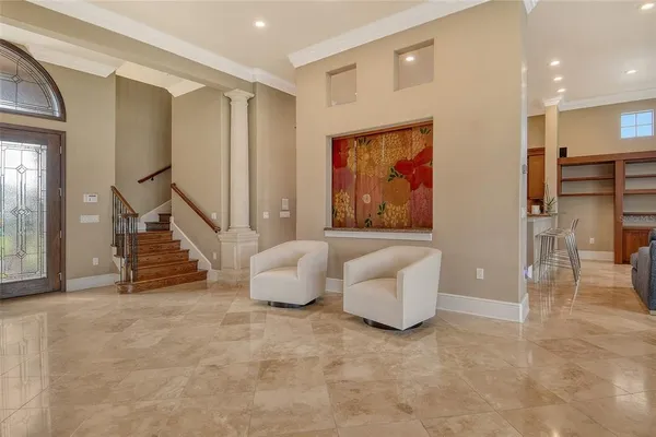 a bedroom with a large bed chandelier and a window