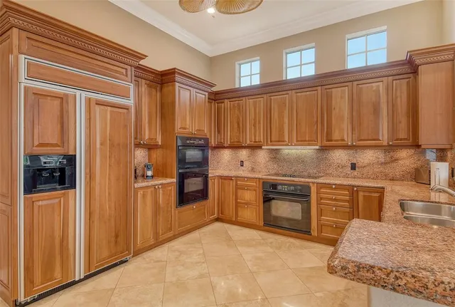 a bathroom with a granite countertop sink and a large mirror