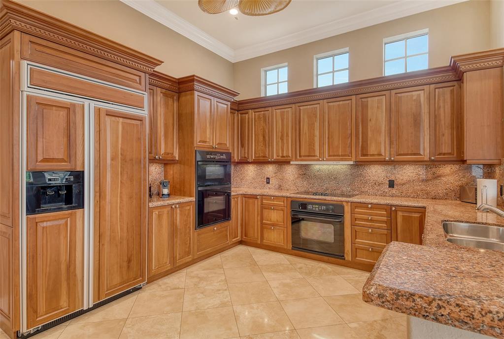591 Putting Green Lane Longboat Key, FL 34228 - Photo 22 of 68 a kitchen with granite countertop stainless steel appliances and wooden cabinets